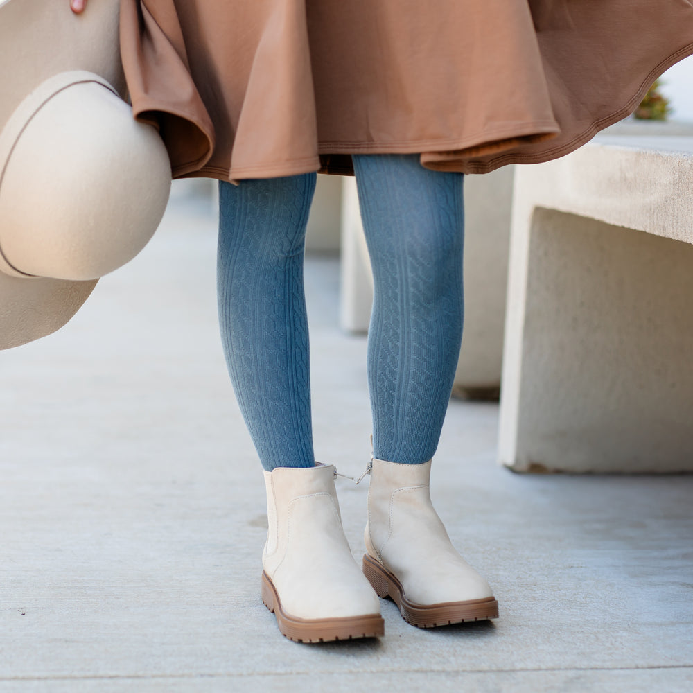 girl wearing denim blue tights with cream boots and mocha brown dress