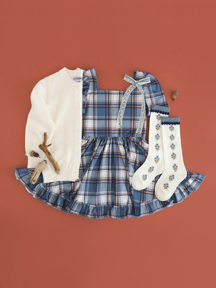 girl's denim plaid square neck twirl dress paired with ivory knit cardigan, ivory knee highs with denim floral design and ivory and denim lace hair bow