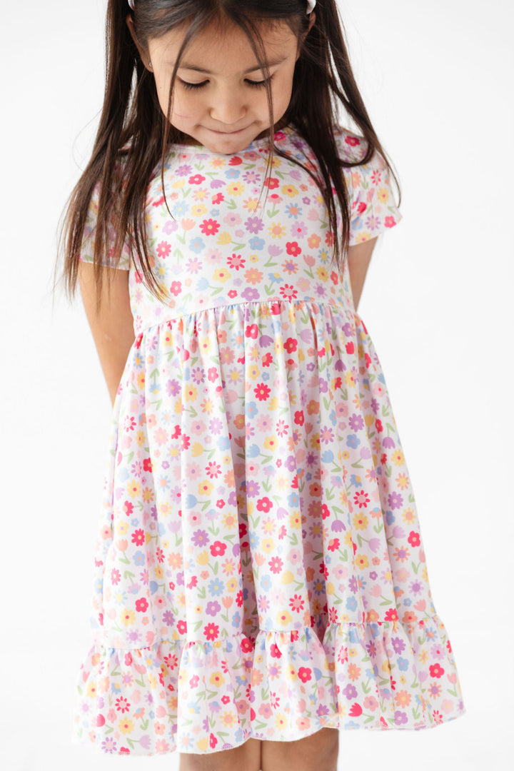 detail photo of little girl in pastel floral print on white twirl dress for pring and easetr