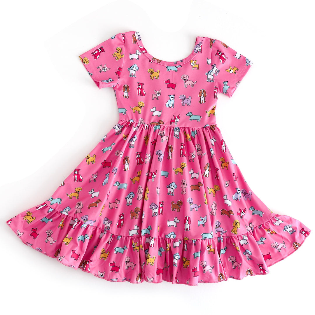 Pink dress with dog pattern on a white background