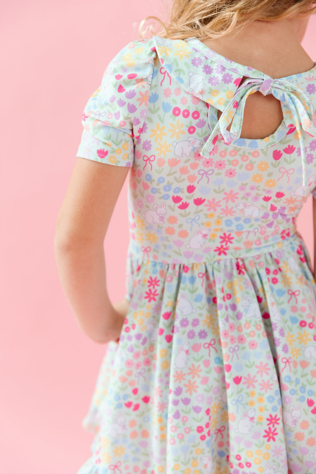 little girl in easter twirl dress with peter pan collar in a pastel flower and bunny print