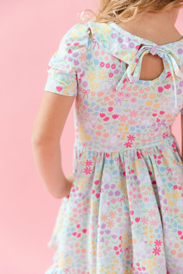 little girl in easter twirl dress with peter pan collar in a pastel flower and bunny print