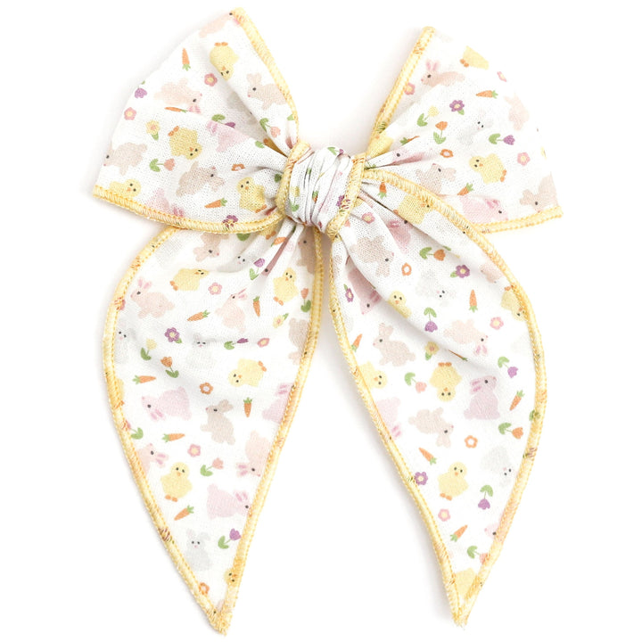 easter hair bow with bunnies, chicks and flowers with pastel yellow trim