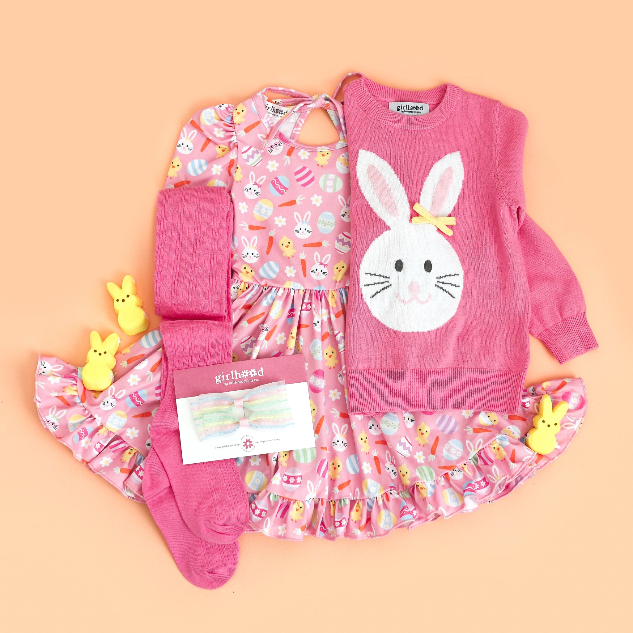 little girl's styled Easter outfit with pink bunny print twirl dress and matching bunny sweater, tights and bows