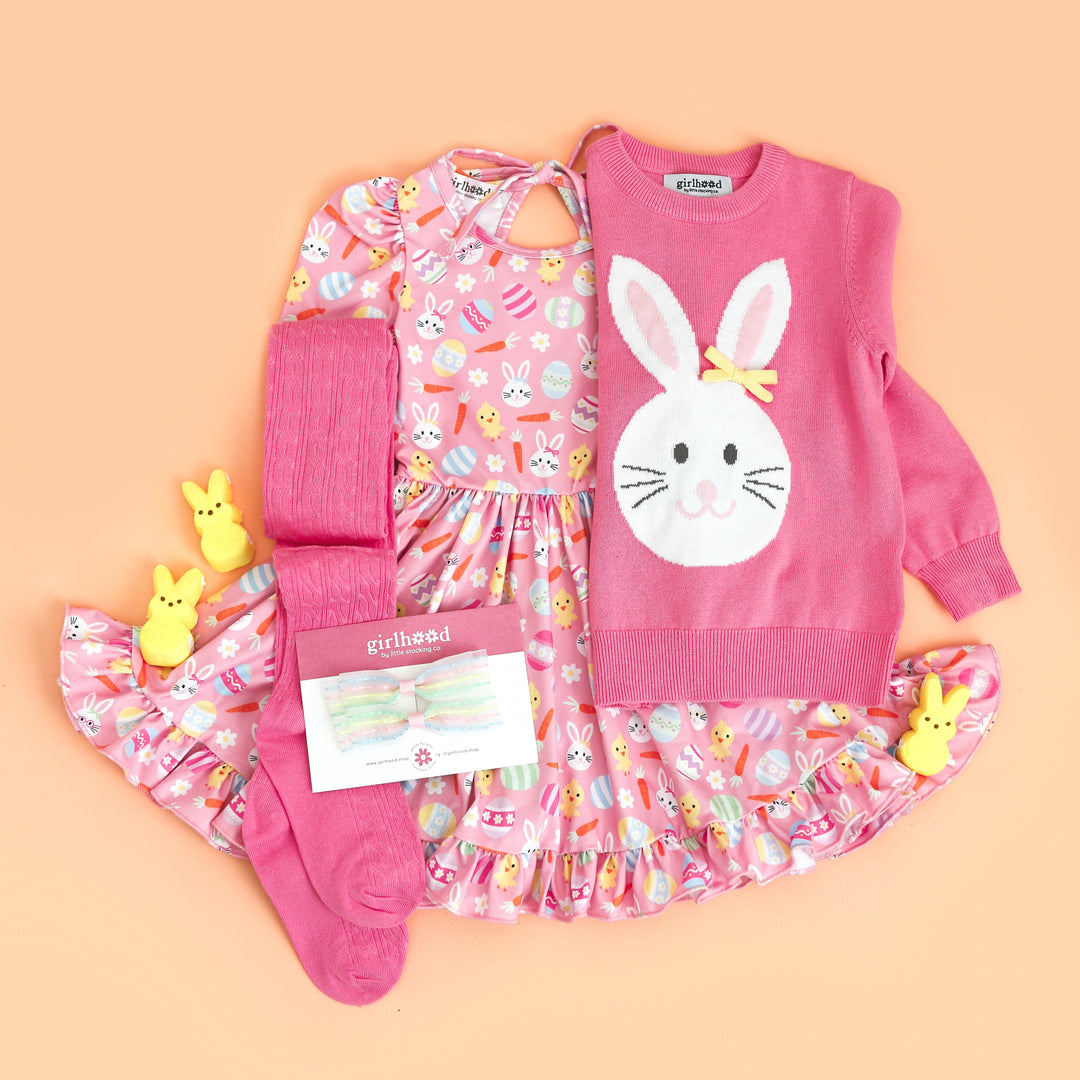 little girl's styled Easter outfit with pink bunny print twirl dress and matching bunny sweater, tights and bows