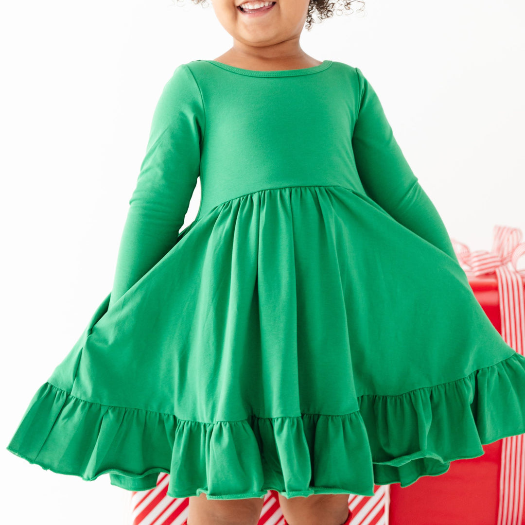 little girl in vibrant green cotton twirl dress with long sleeves for Christmas party