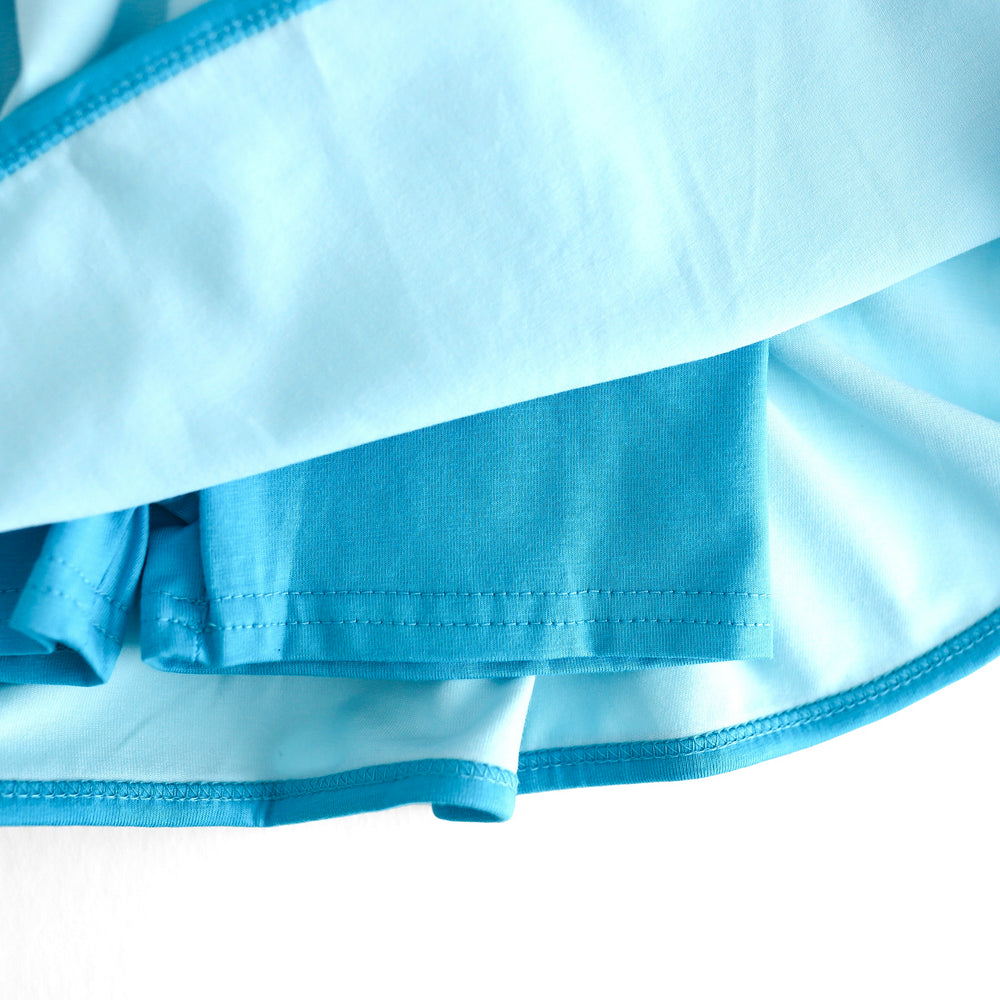 closeup of bright blue built in biker shorts on girl's summer skort