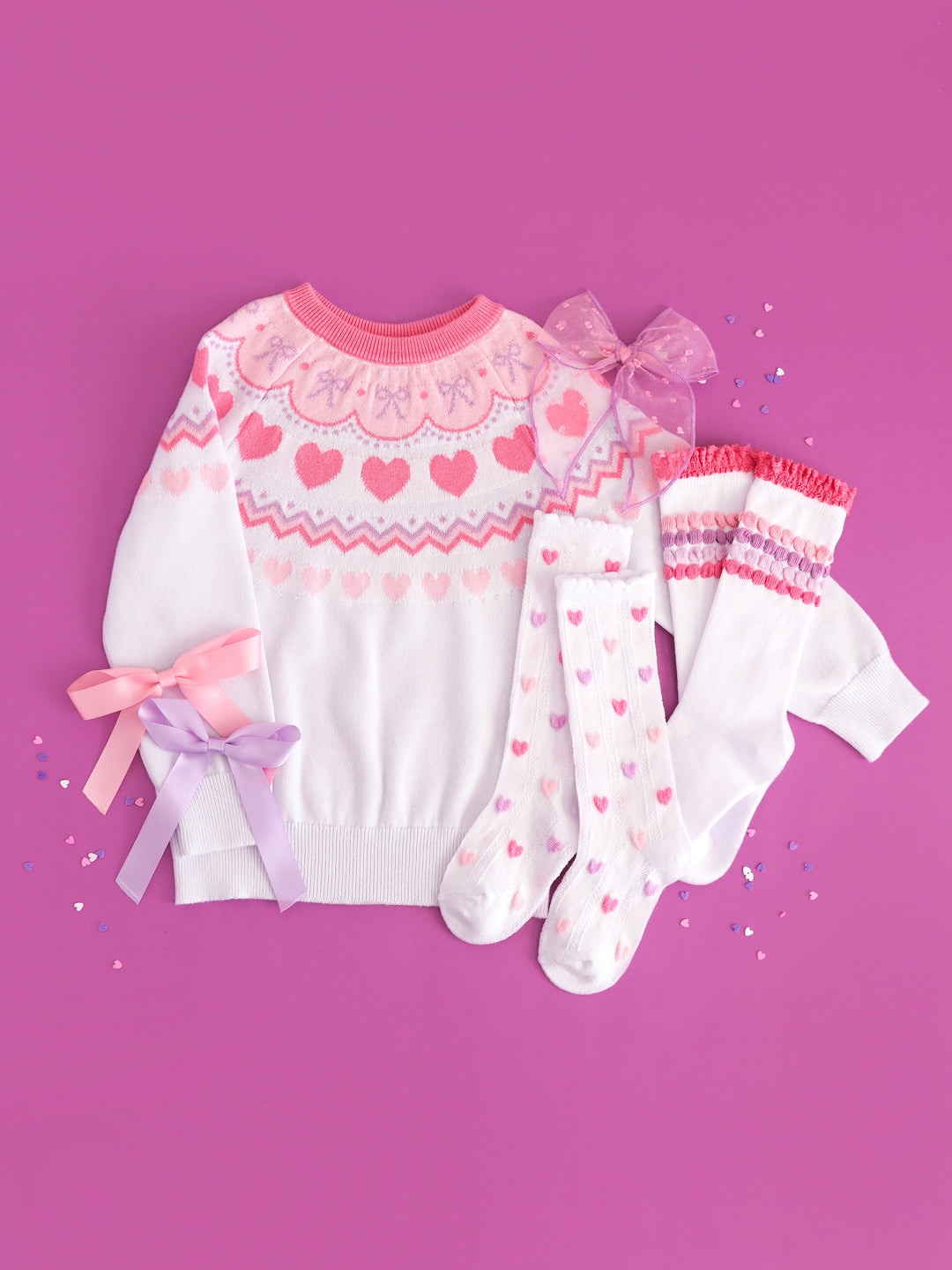girl's white knit sweater with pastel valentines fair isle design, pastel heart and stripe knee socks and coordinating satin ribbon bows in pink and lavender