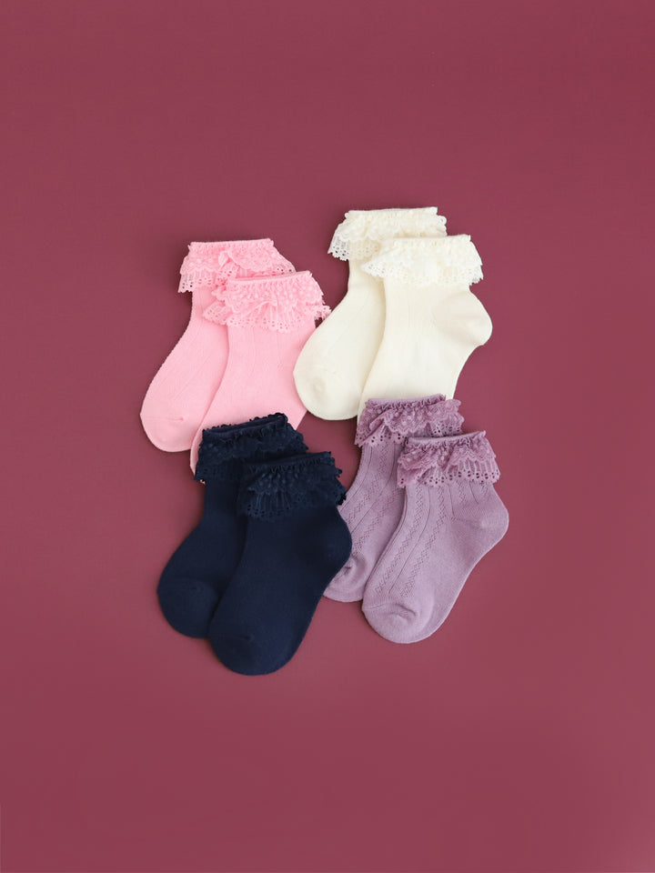 flatlay of girls' lace trim bobby socks in pink, ivory, navy and purple for fall