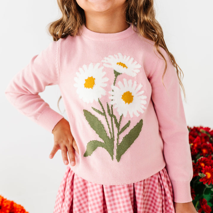 little girl in pink cotton knit pullover with white daisy design paired with pink gingham twirl dress