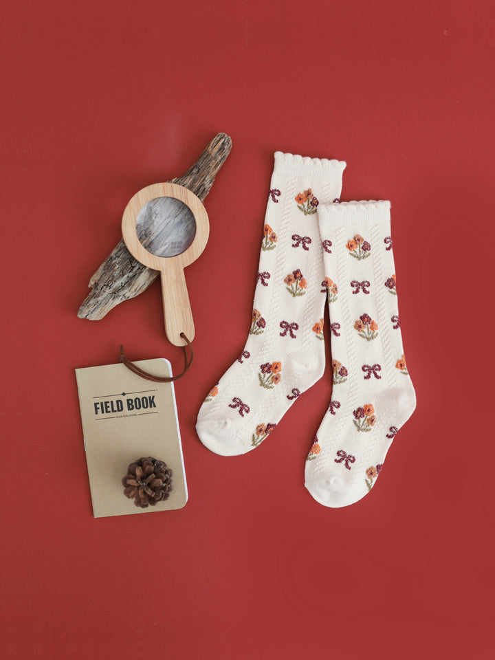 girls' cream knee high socks with scalloped trim and fall floral and bow design