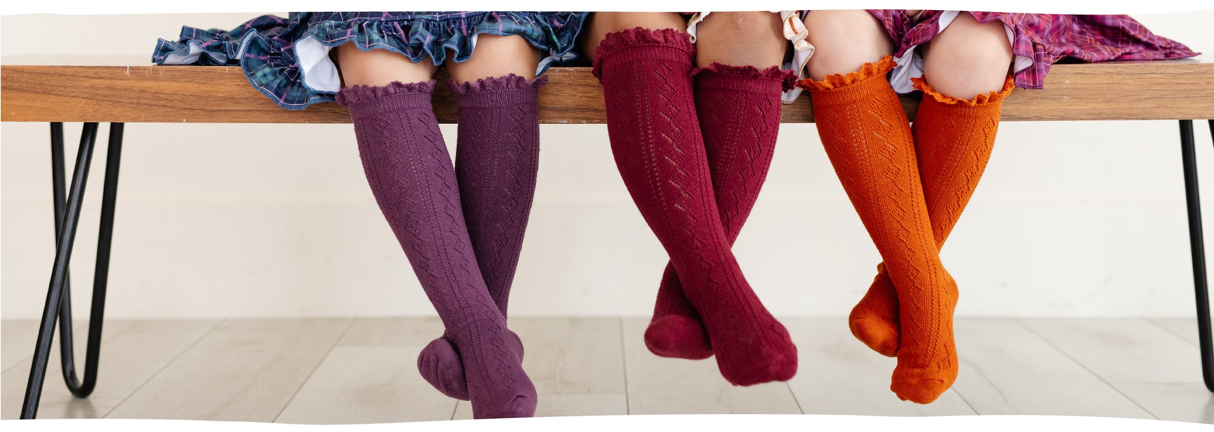 girls sitting on bench wearing fancy crochet knit knee high socks
