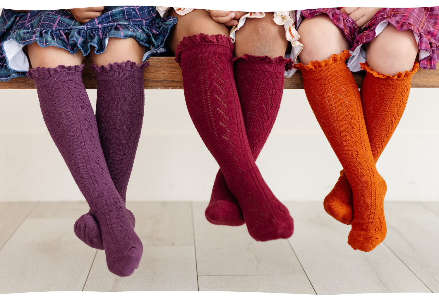 girls crossed legs in fancy crochet knee high socks with lace