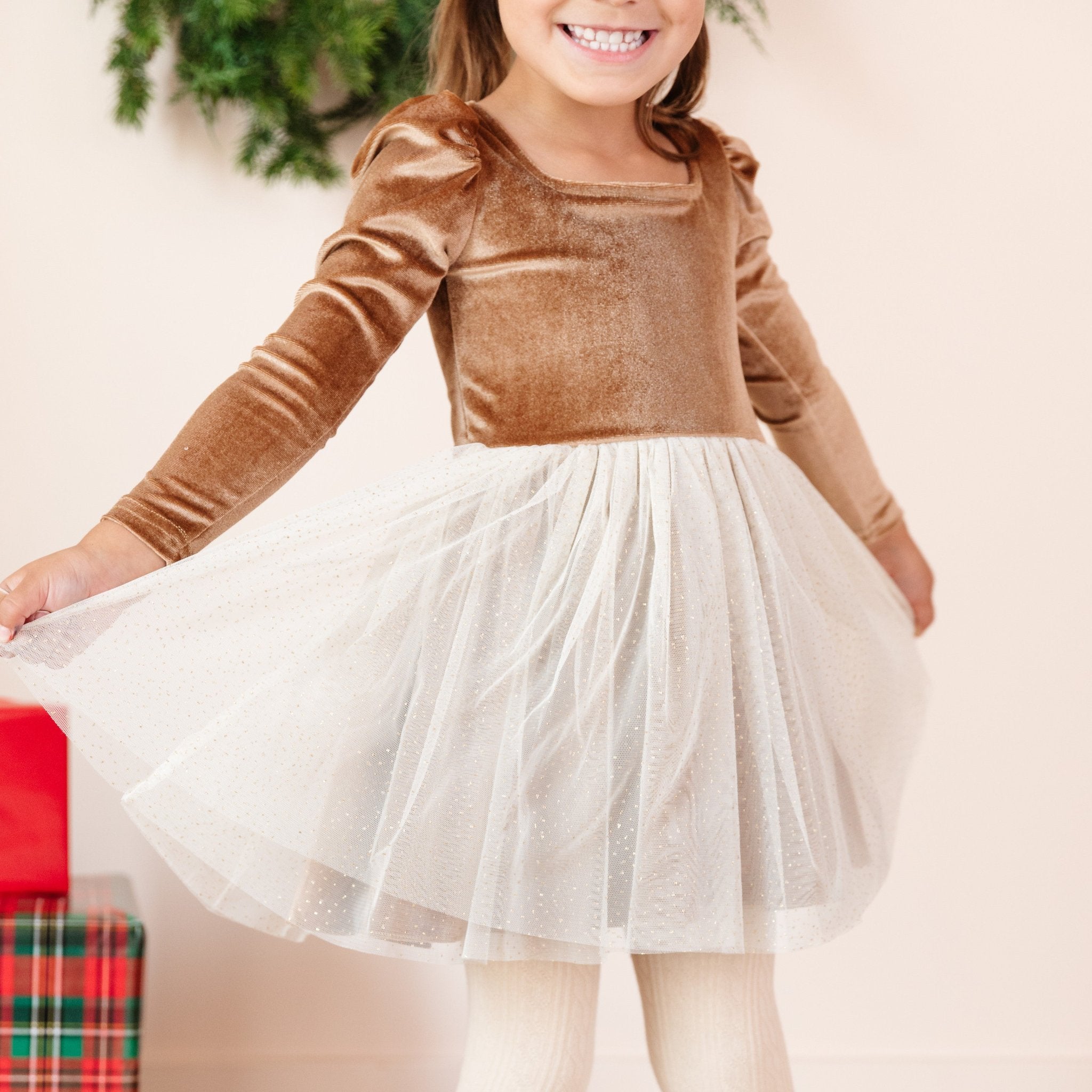 little girl in gold velvet tutu dress with glittery cream tutu skirt for Christmas party