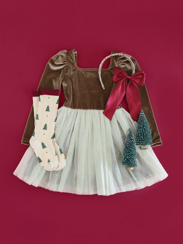 flat lay of girls' golden brown velvet long sleeve tutu dress with cream tulle, matching cream socks with Christmas tree design and crimson satin hair bow