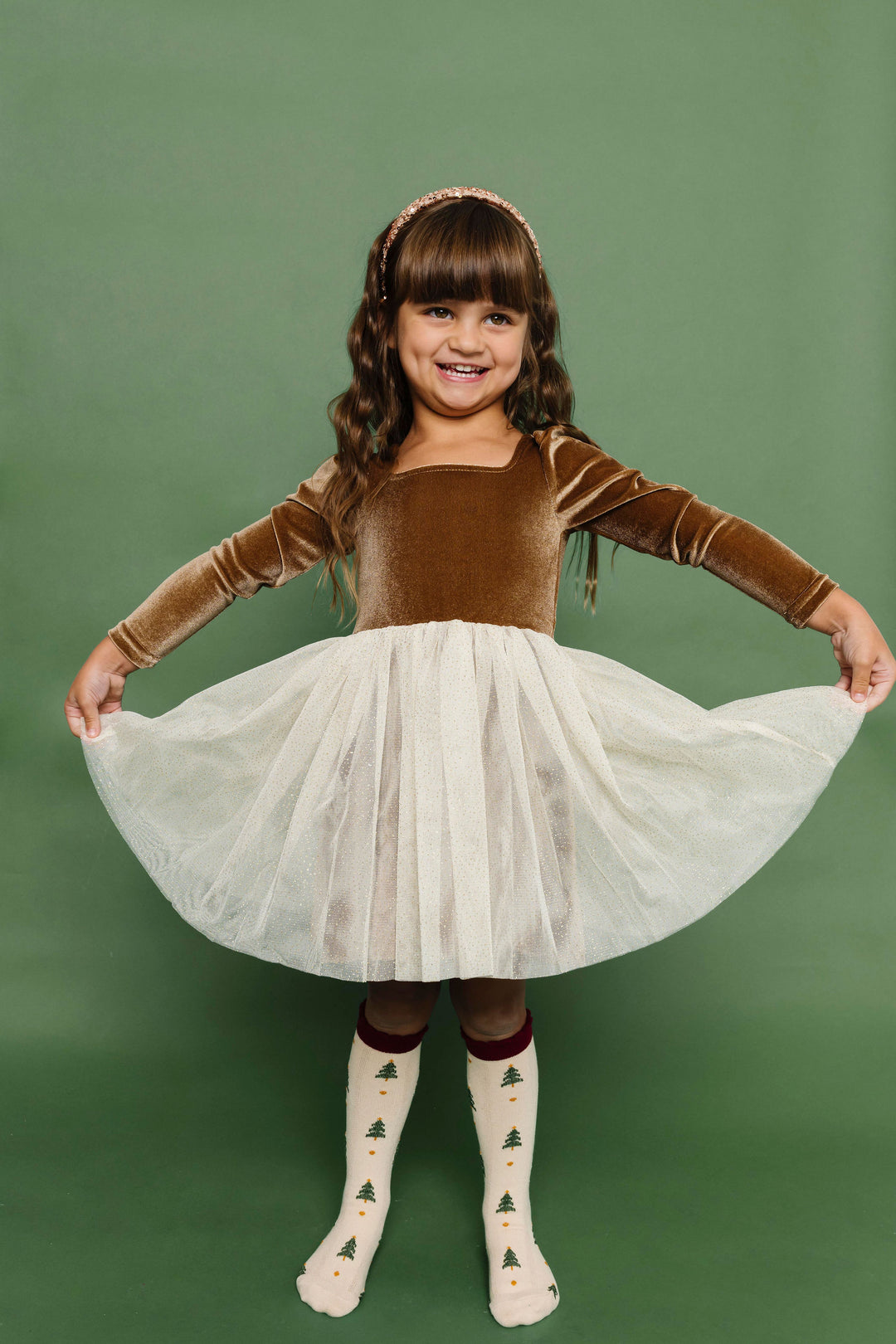 little girl in golden brown velvet tutu dress paired with Christmas tree print knee high socks 