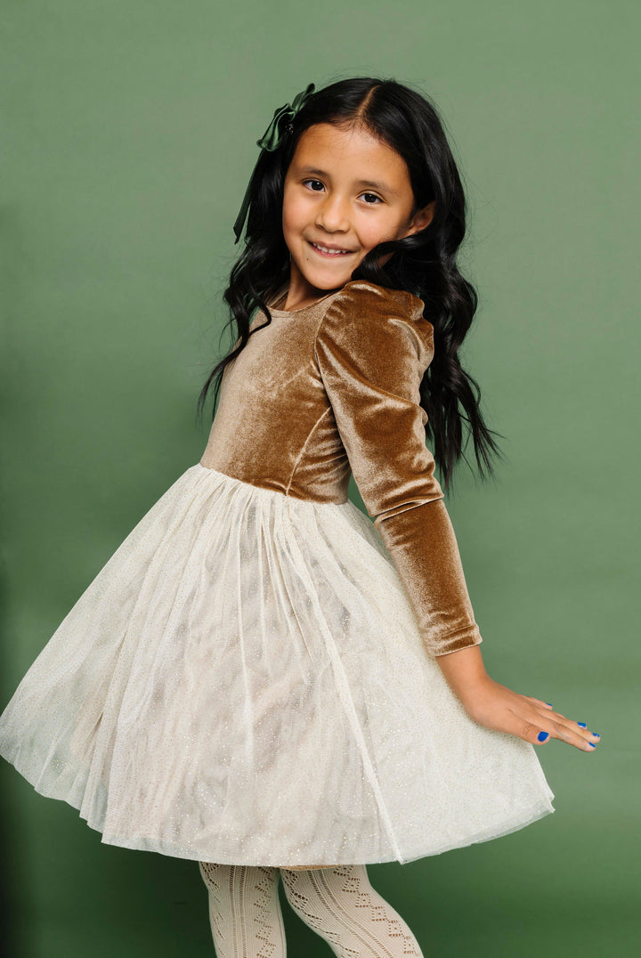 little girl in vintage gold and cream tutu velvet dress, green satin bow and cream open knit tights for Chrismtas party 