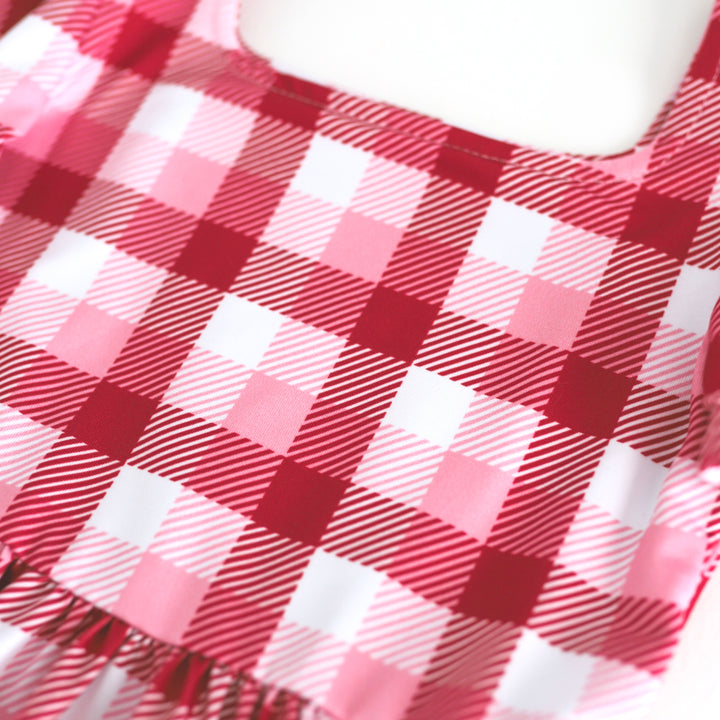 closeup of girls' plaid dress in red, white and pink for Valentine's Day