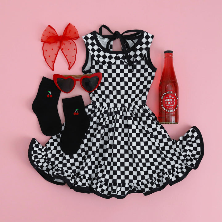 checkered summer twirl dress paired with cherry socks and bright red hair bow
