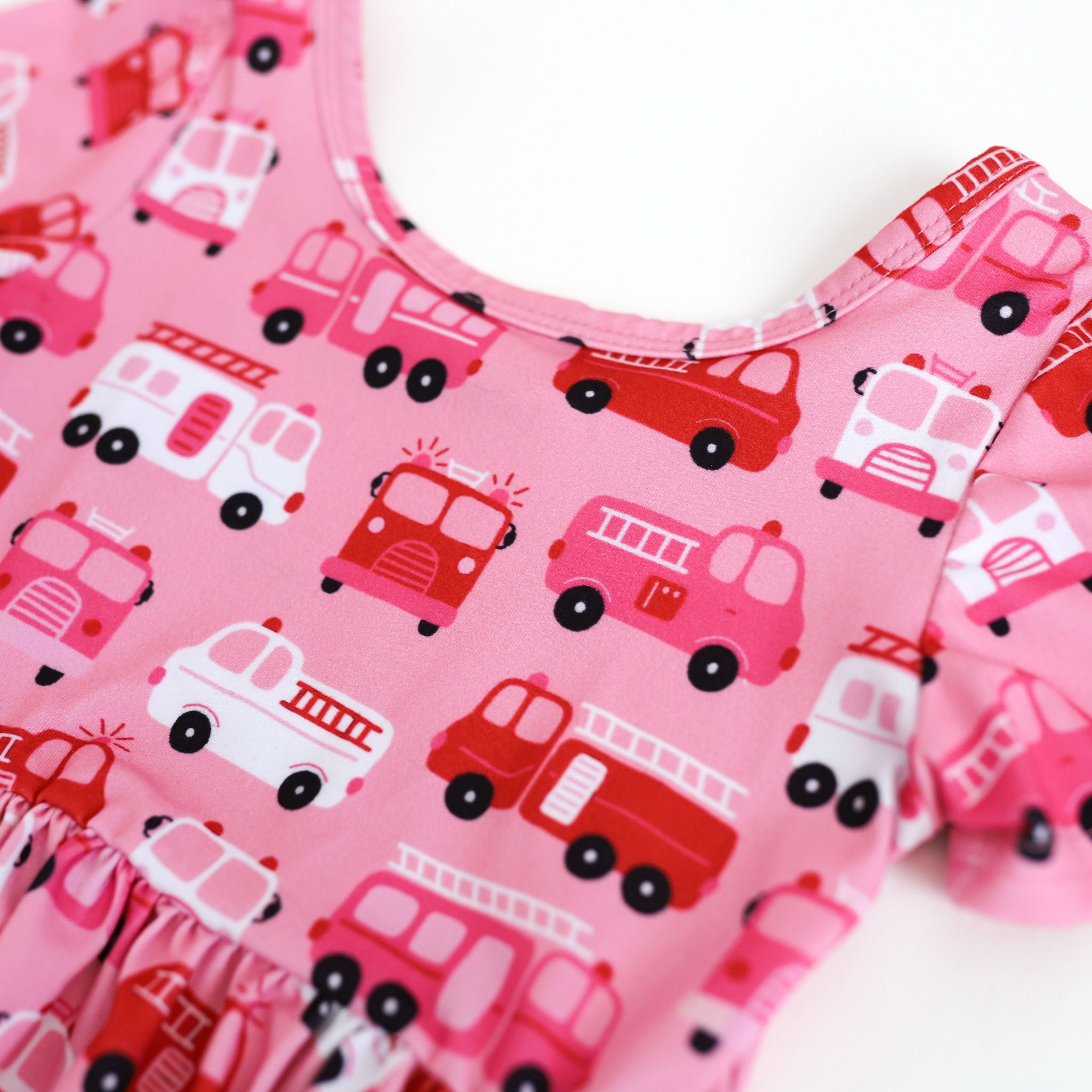 closeup of pink, red and white firetruck print dress for Valentine's Day