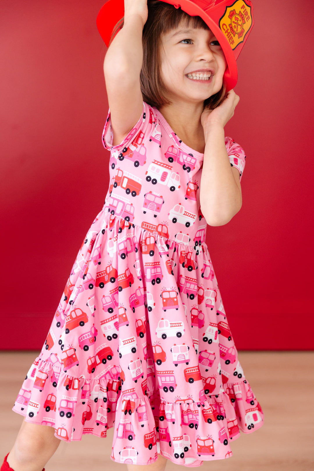 little girl in red and pink Valentine's fire truck print twirl dress