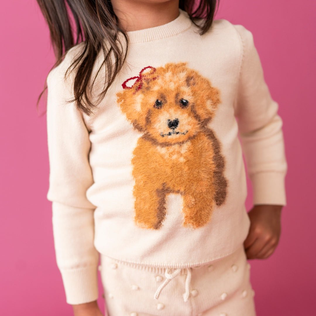 closeup of fluffy yarn dog design on cream cotton pullover sweater 