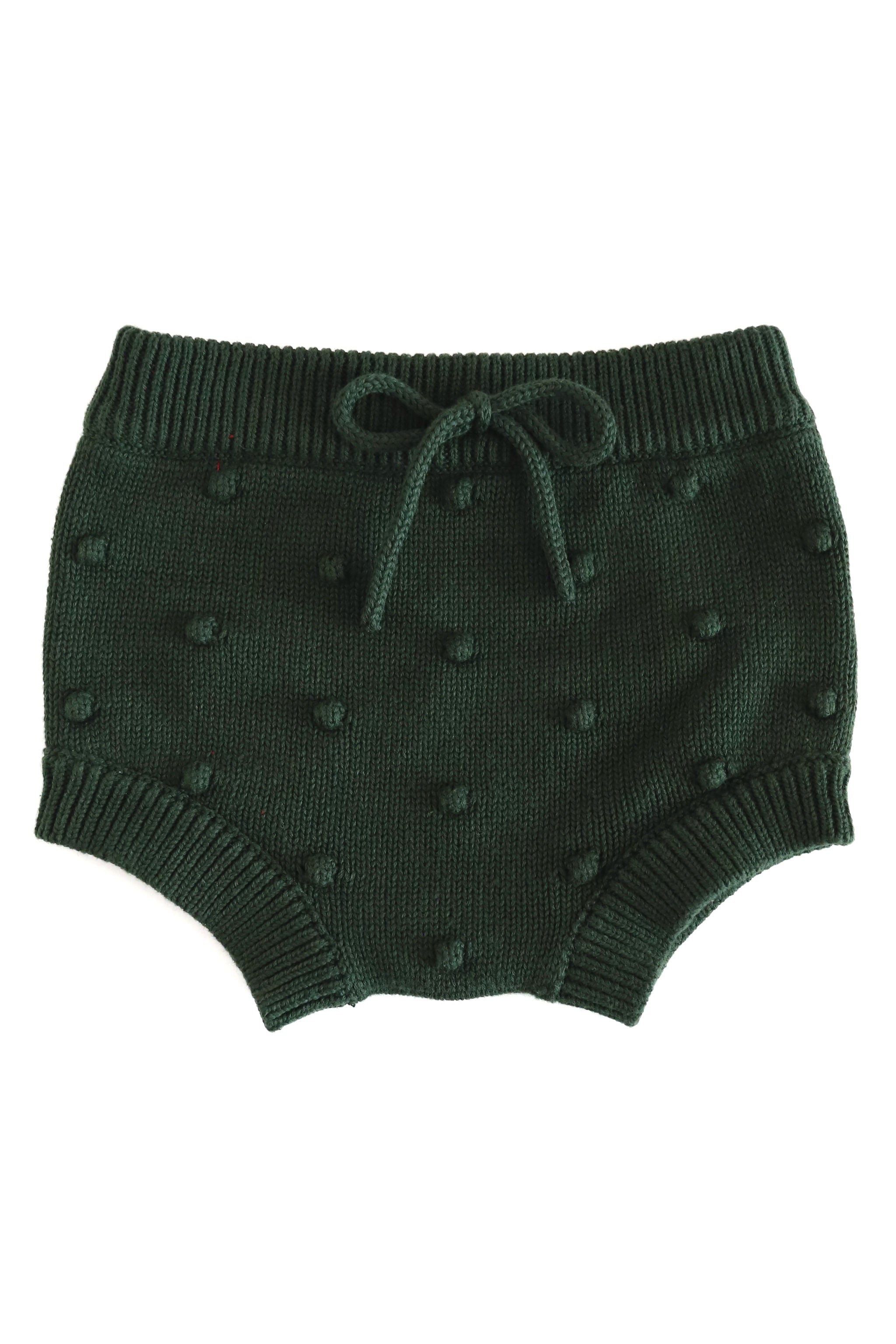 Dark green knit baby bloomers with a textured pom-pom pattern and a matching faux bow at waist, shown against a plain white background.