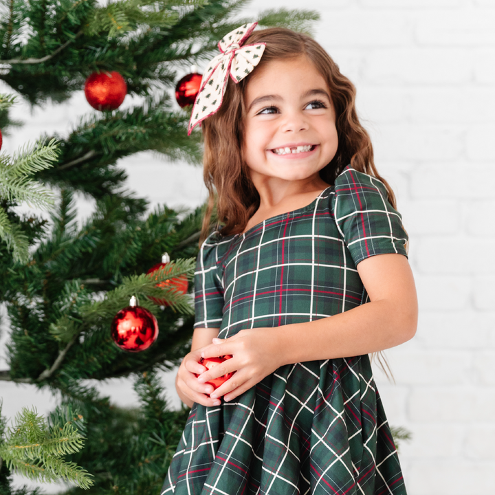 forest christmas plaid dress on girl by christmas tree