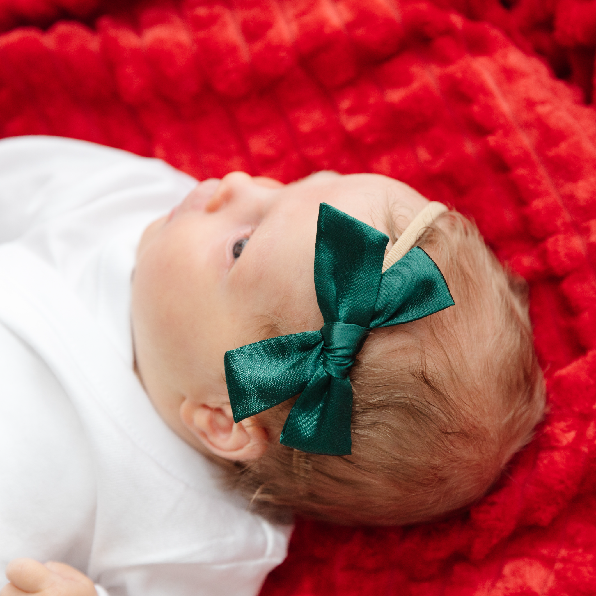 baby girl in green satin Christmas bow on soft nylon headband