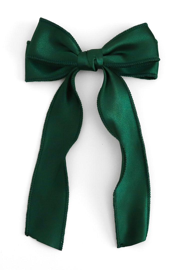 dark green satin hair bow with long tails photographed on solid white background
