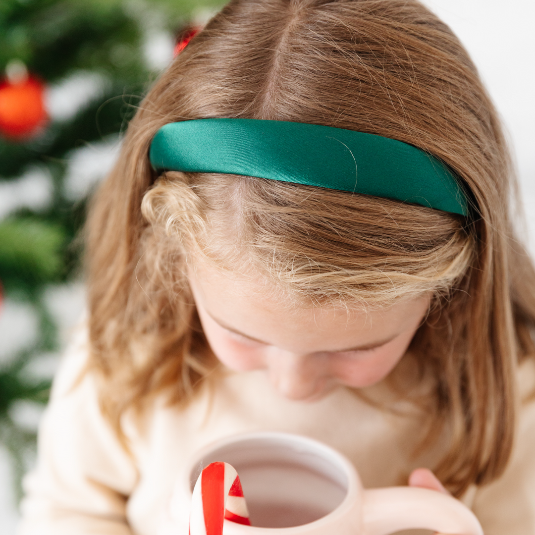 little girl in Christmas green satin headband