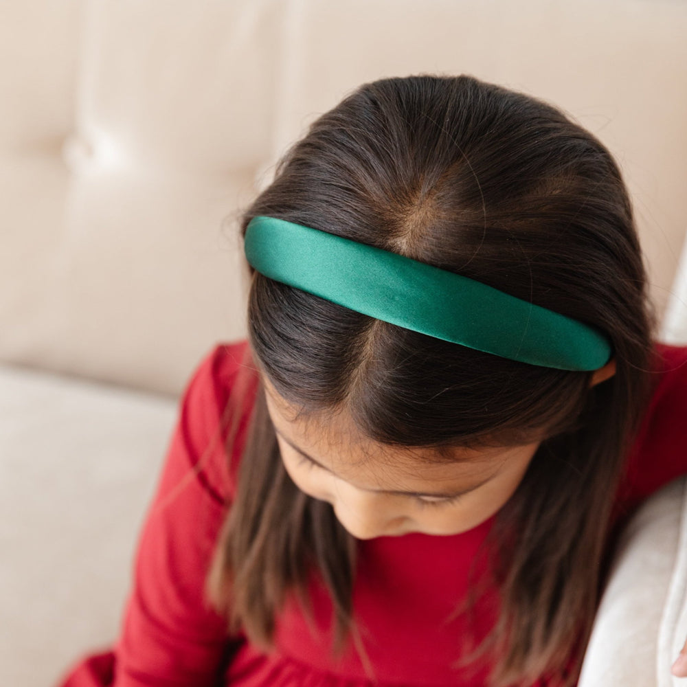 girl in holiday green satin headband and red dress