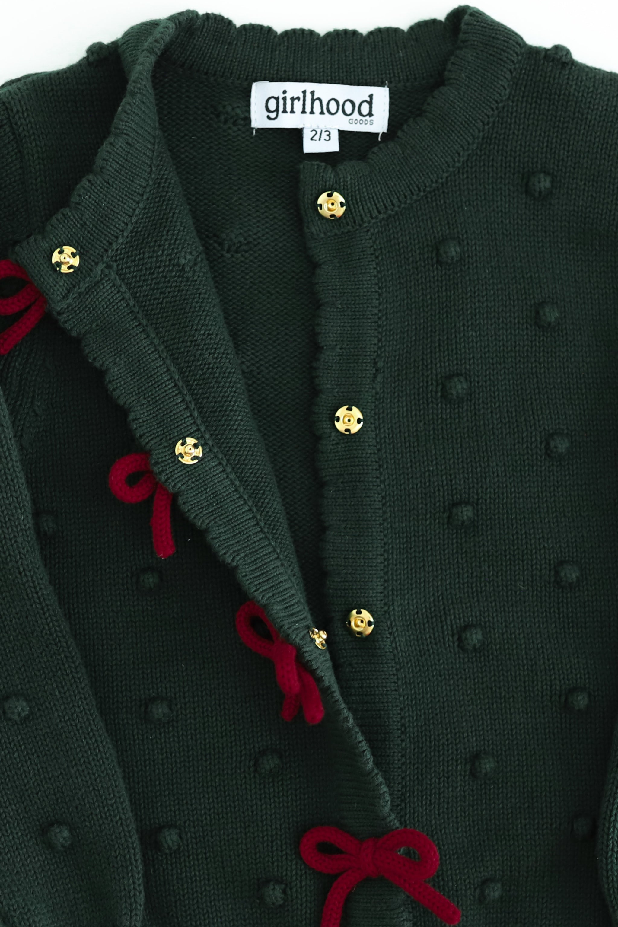 girls' forest green cotton knit cardigan with raised bubble texture and crimson knit bows on snap front