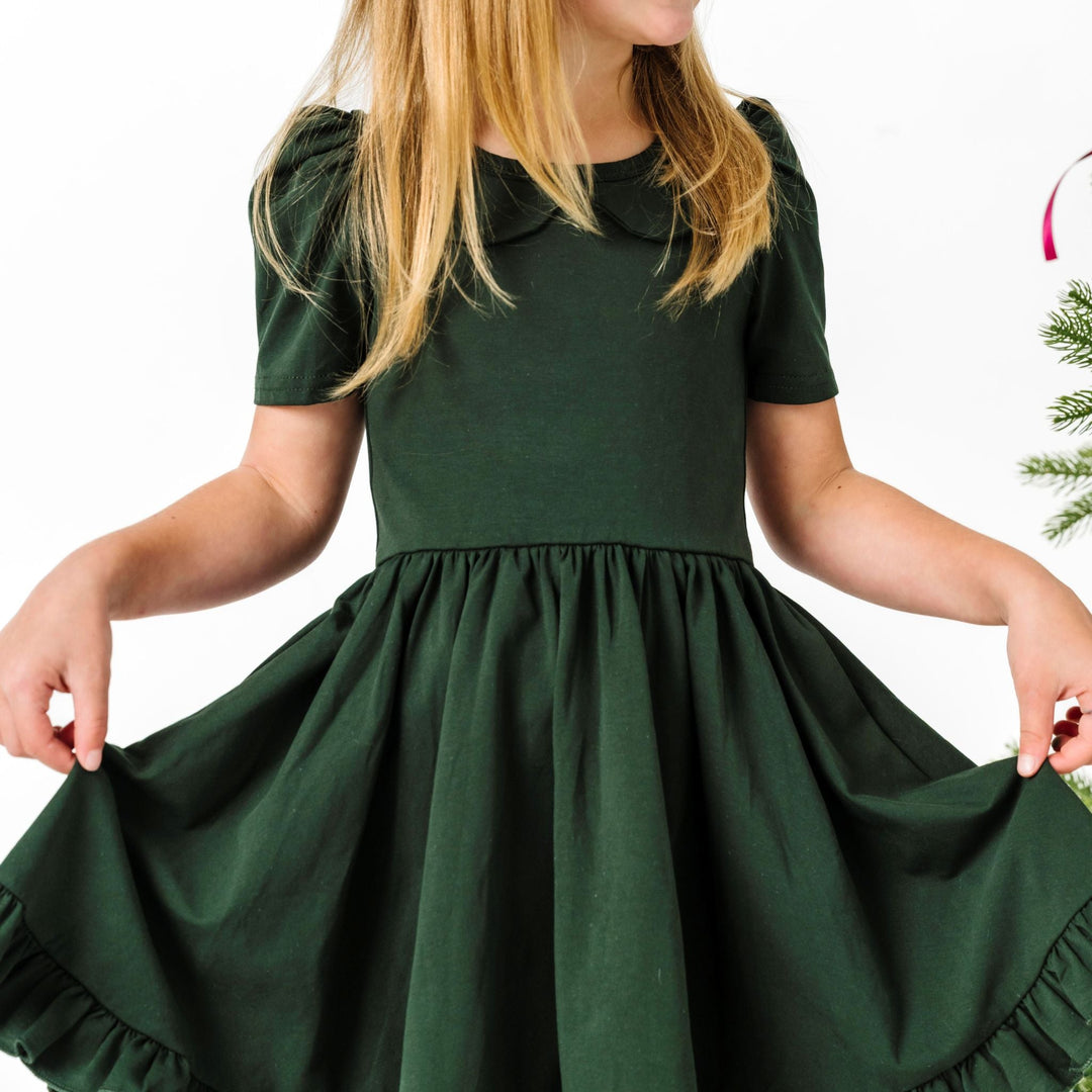 closeup of girl in forest green collared twirl dress for Christmas
