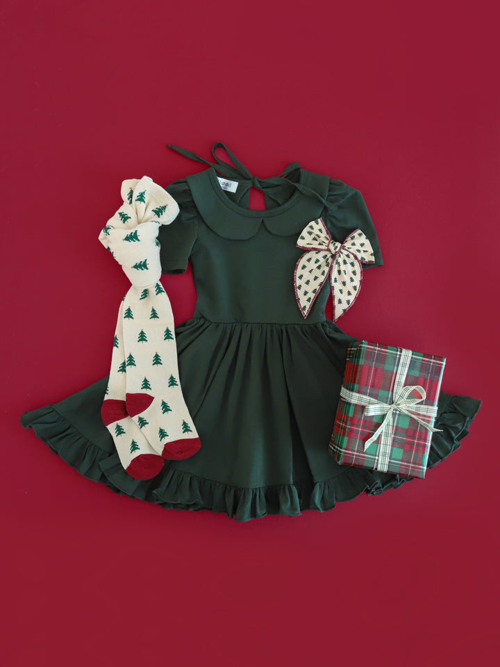 girls' Christmas outfit with forest green collared twirl dress paired with Christmas tree print tights and hair bow