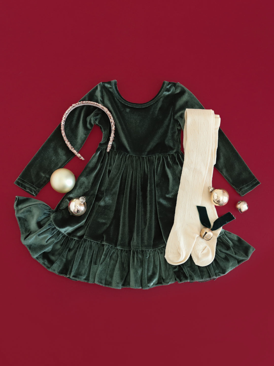 girls' forest green long sleeve velvet Christmas dress with sparkly gold headband and cream cable knit tights