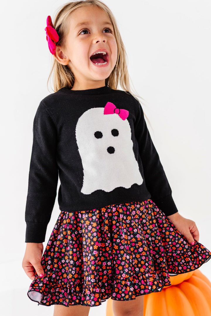 little girl wearing ghost pullover sweater with halloween floral dress layered