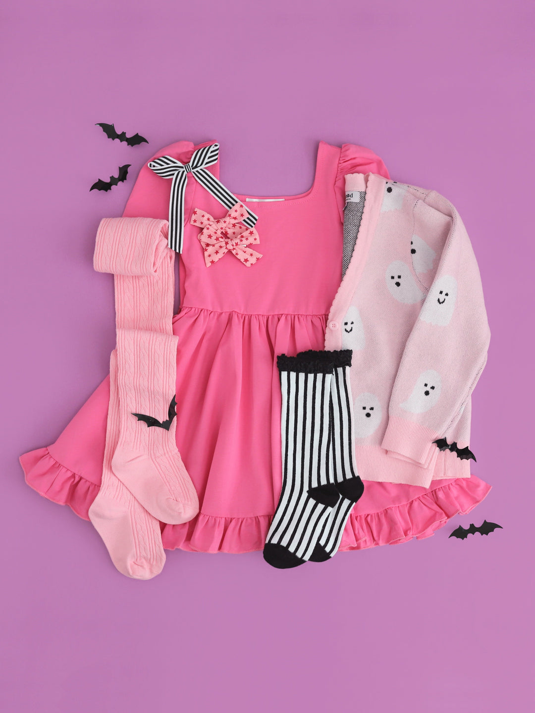 girls' pink square neck twirl dress paired with cozy v-neck cardigan with all-over ghost design and matching Halloween socks and bows 