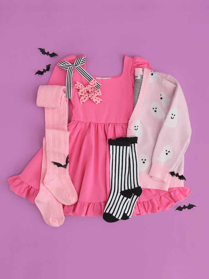 girls' pink square neck twirl dress paired with cozy v-neck cardigan with all-over ghost design and matching Halloween socks and bows 