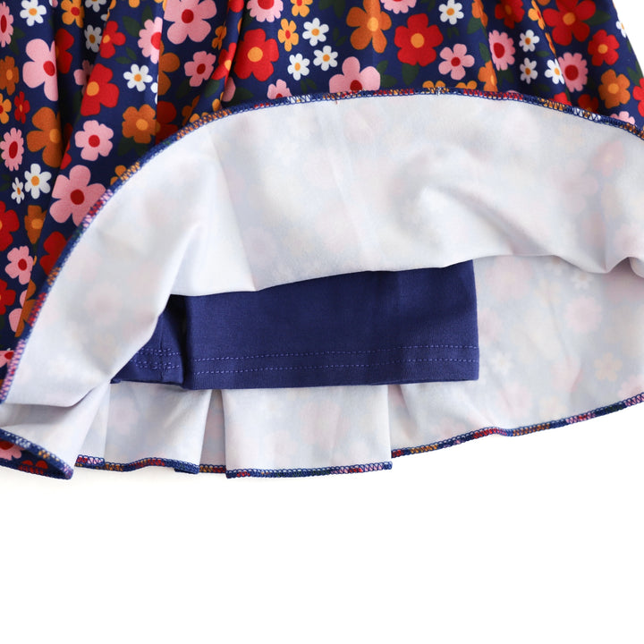 view of navy shorts inside girls back to school floral skort with navy background and red, yellow, pink and white flower print