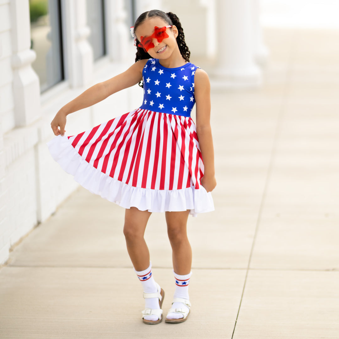 girl wearing american flag dress with star glasses for 4th of july