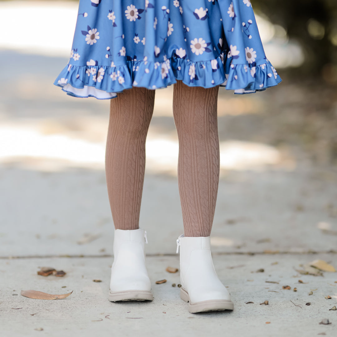 mocha brown cable knit tights on little girl wearing blue dress and boots