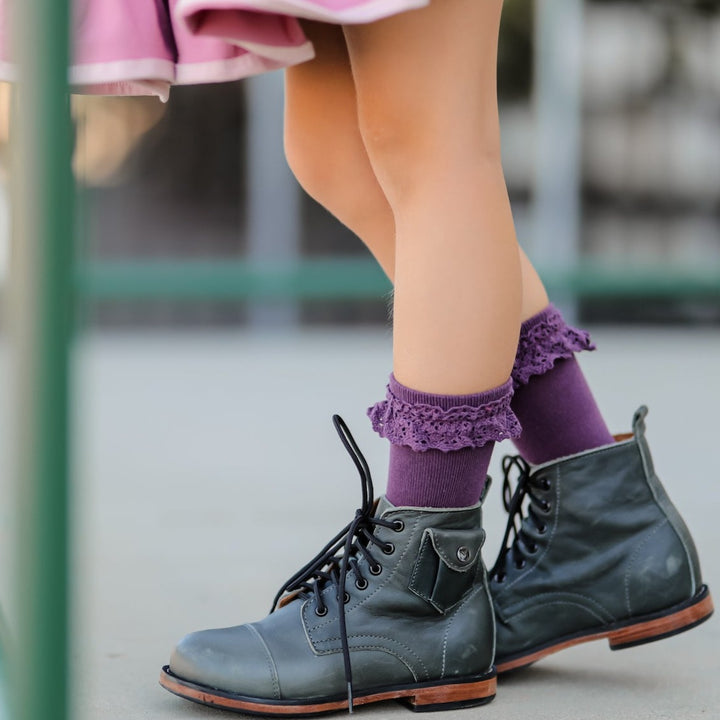 plum lace ruffle midi socks on little girl wearing black boots
