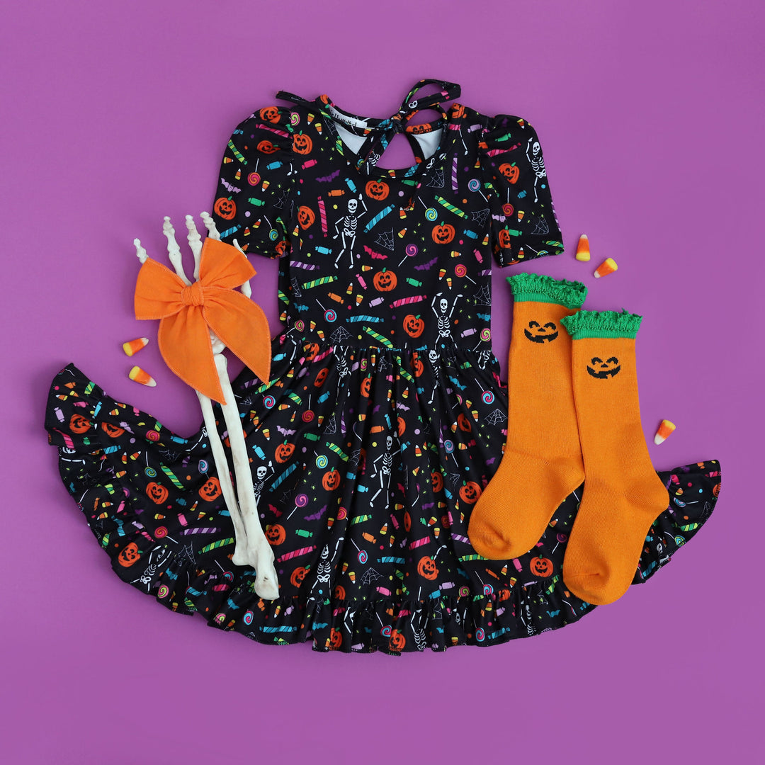 girls halloween outfit with matching pumpkin socks and orange hair bow