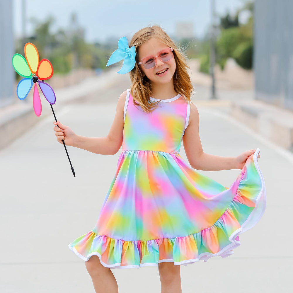 little girl wearing bright rainbow tie-dye style summer tank top dress