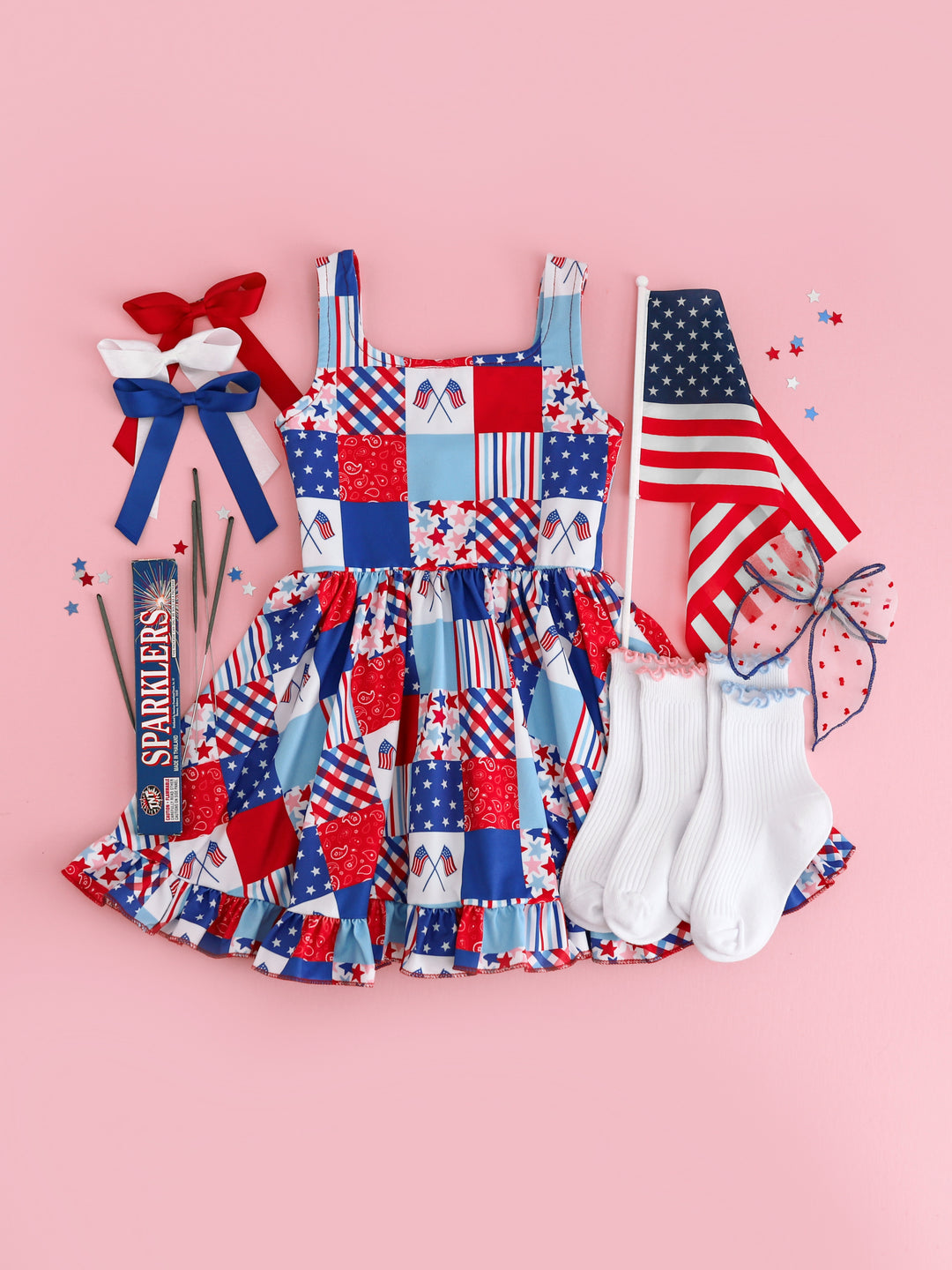 girls sleeveless twirl dress with red, white and blue patchwork print styled with sparklers, american flag, matching satin bows and ruffle trim socks