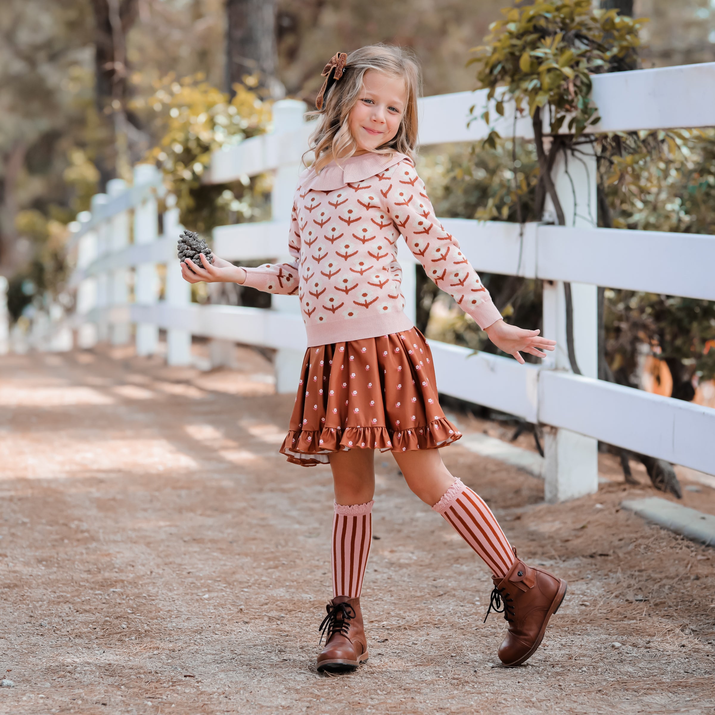 little girl in blush and and bronze fall floral outfit with matching lace top knee high socks
