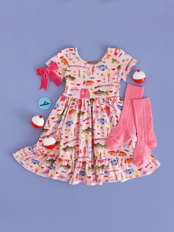 styled photo for girls' pink fishing themed twirl dress with matching pink knee high socks and velvet pink ribbon bow on clip