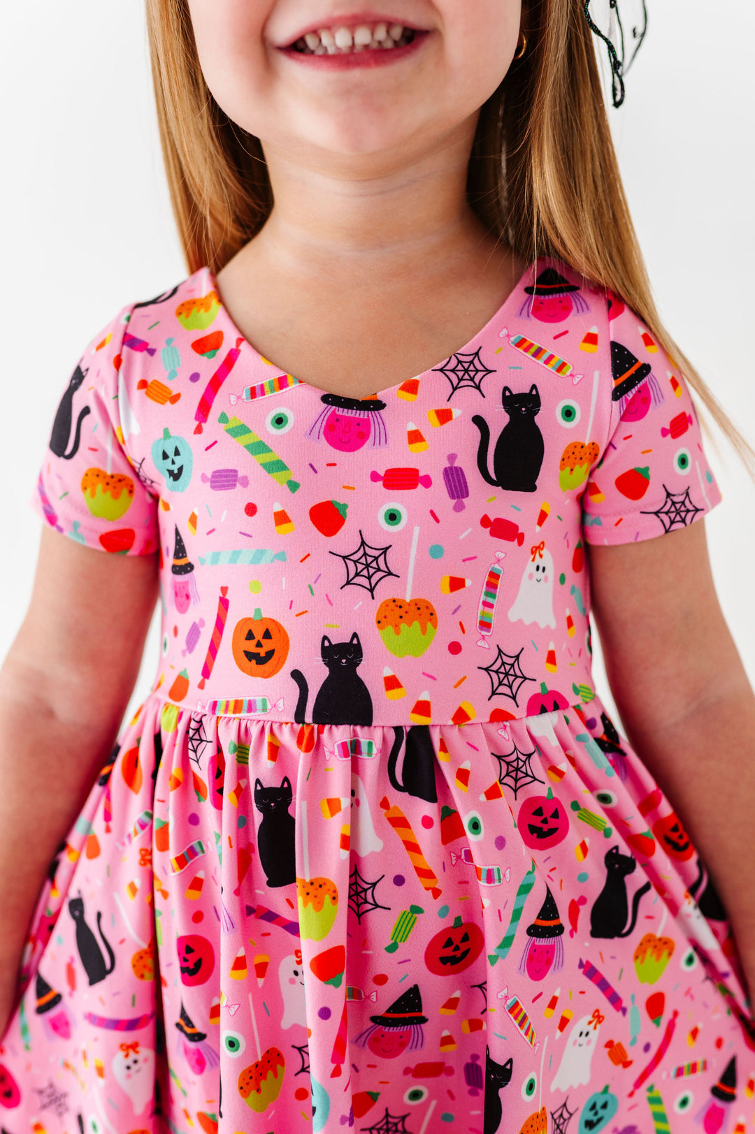 details of pink halloween print dress with candy, cats, pumpkins, ghosts and witches