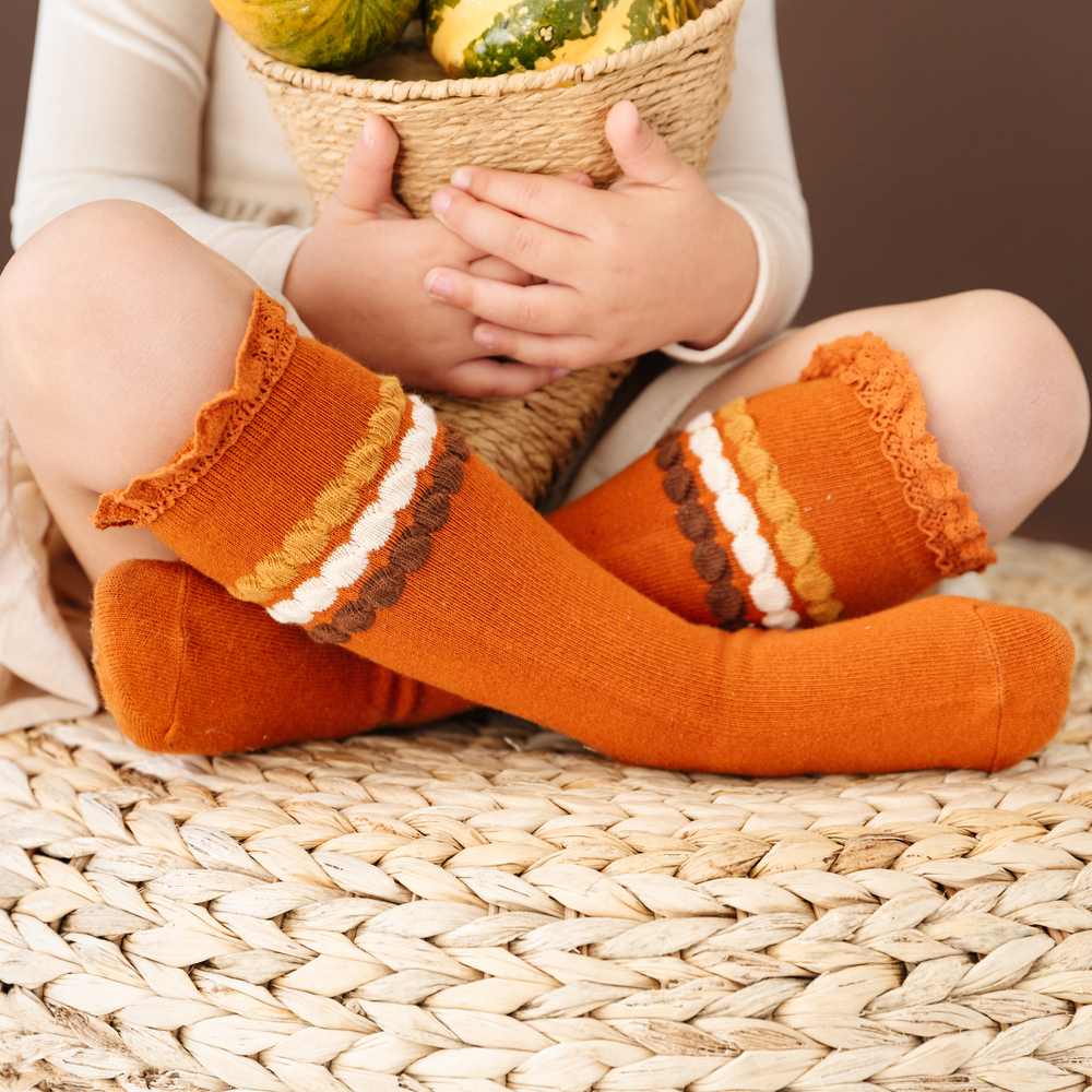 girls knee highs socks for fall in pumpkin orange with brown, gold and cream stripe